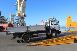A truck being rolled on board the ship.