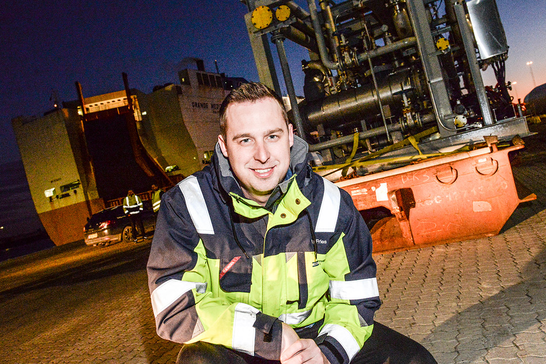 Henning Fries, Port Captain for Scandinavian Auto Logistics, inspecting cargo on a Mafi-Trailer beside a Grimaldi Lines ship.