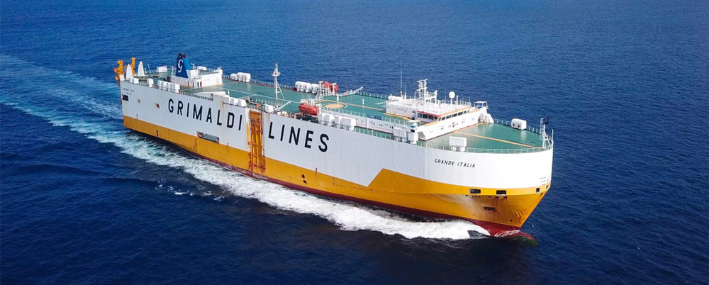 Grimaldi Lines Grande Italia. freighter, symbolizing the company's commitment to environmental policies and compliance with the EU Emissions Trading System effective from 01/01/2024. The ship represents Grimaldi's efforts to reduce CO2 emissions and implement new technologies for a sustainable future.
